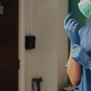 doctor-putting-glove-prevent-coronavirus-contamination